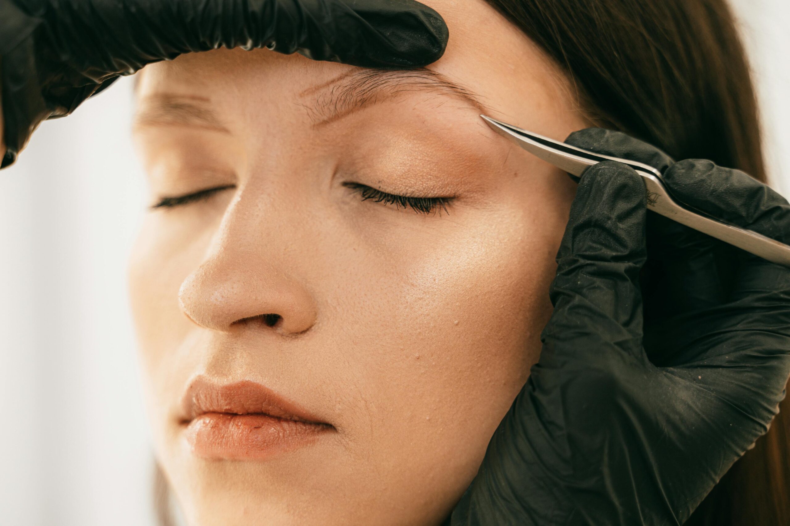 What is the best way to shape your eyebrows at home with tweezers?